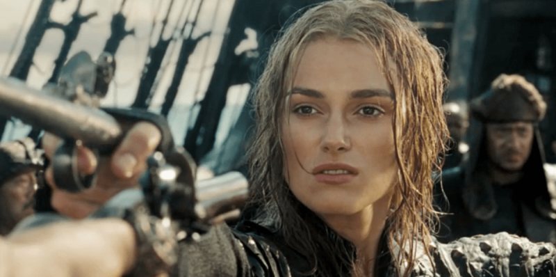   Бела жена мокре косе упире пиштољ док стоји на броду у"Pirates of the Caribbean" franchise films