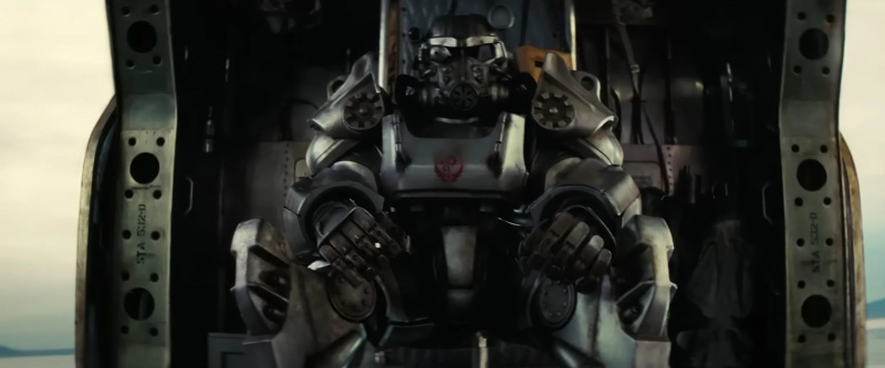   Captura de pantalla de alguien con armadura de la Hermandad del Acero en el'Fallout' show. They are sitting in a Vertibird. 